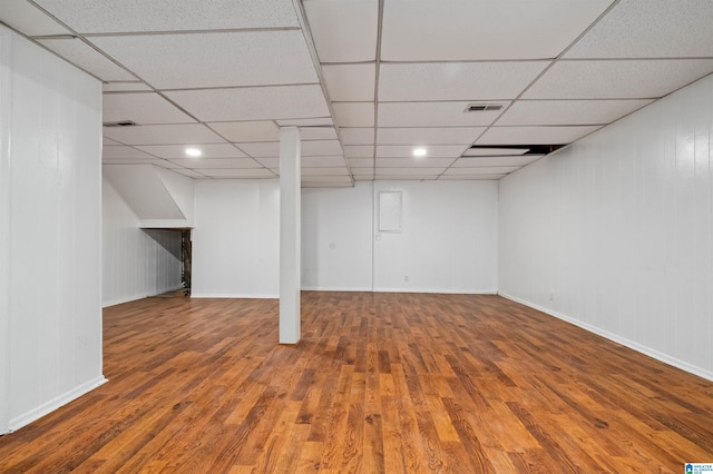 basement with hardwood / wood-style flooring and a paneled ceiling