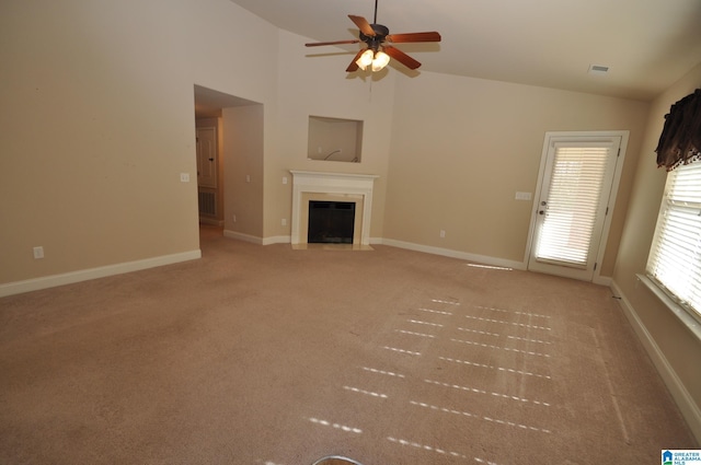 unfurnished living room featuring ceiling fan, lofted ceiling, and light carpet