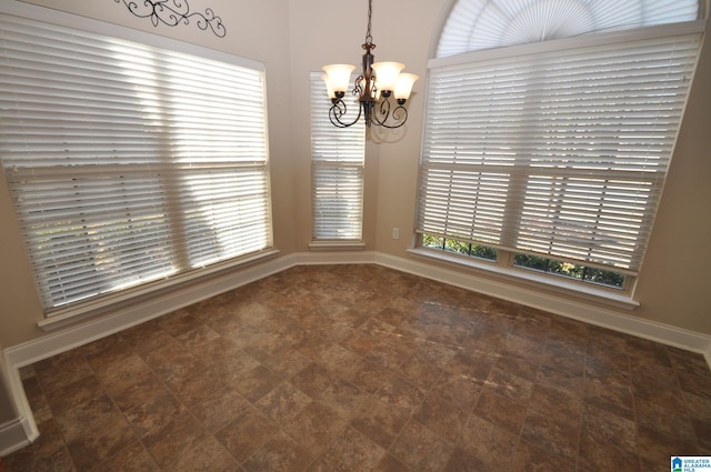 unfurnished dining area with an inviting chandelier