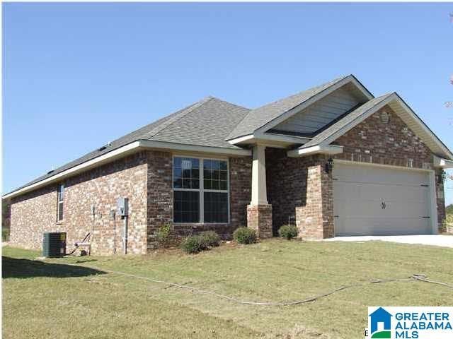 craftsman inspired home with a garage, a front yard, and central AC unit