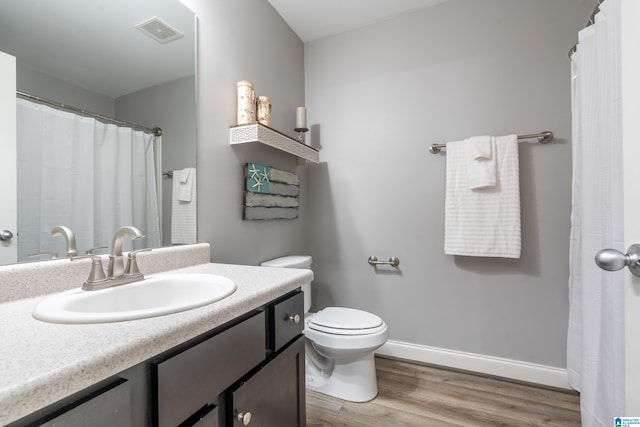 bathroom with vanity, hardwood / wood-style floors, and toilet