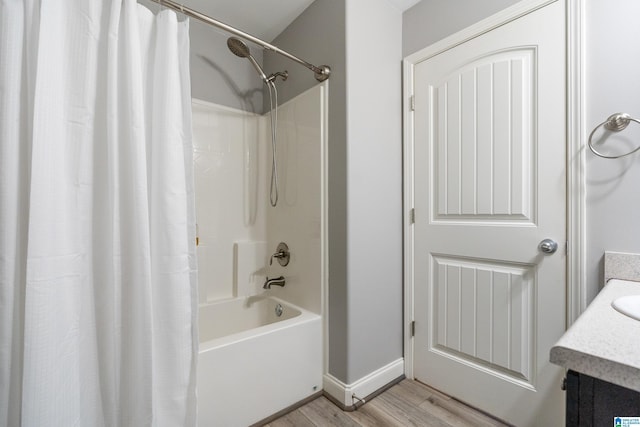 bathroom with vanity, hardwood / wood-style floors, and shower / bath combo