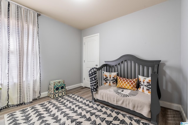 bedroom with hardwood / wood-style flooring