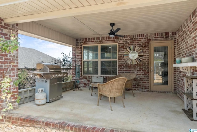 view of patio with area for grilling and ceiling fan