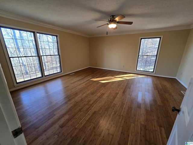 empty room with ceiling fan, ornamental molding, dark hardwood / wood-style flooring, and a textured ceiling