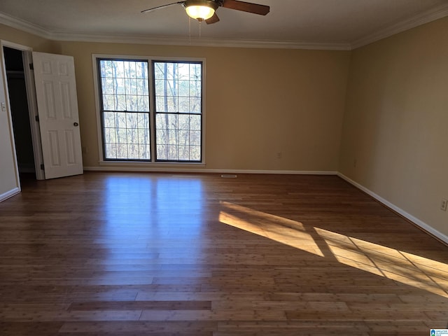 unfurnished room with crown molding, ceiling fan, and dark hardwood / wood-style flooring