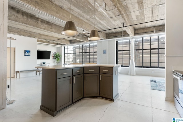 kitchen with pendant lighting, dark brown cabinetry, and electric range