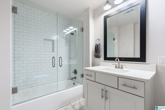 bathroom with vanity and shower / bath combination with glass door