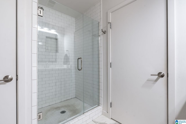 bathroom featuring a shower with door