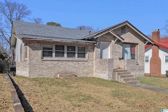 bungalow-style house with a front lawn