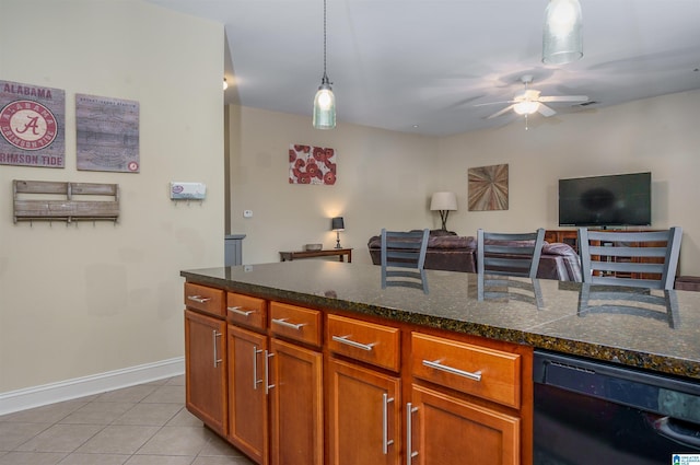 kitchen with light tile patterned floors, hanging light fixtures, dark stone counters, and black dishwasher