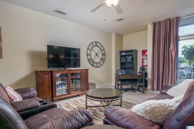 living area featuring light tile patterned flooring, visible vents, and ceiling fan