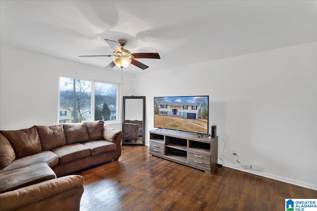 living room featuring ceiling fan and dark hardwood / wood-style flooring