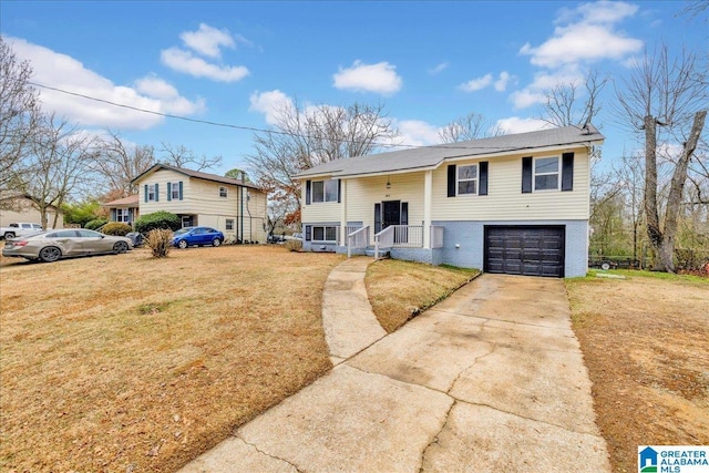 bi-level home featuring a garage and a front yard