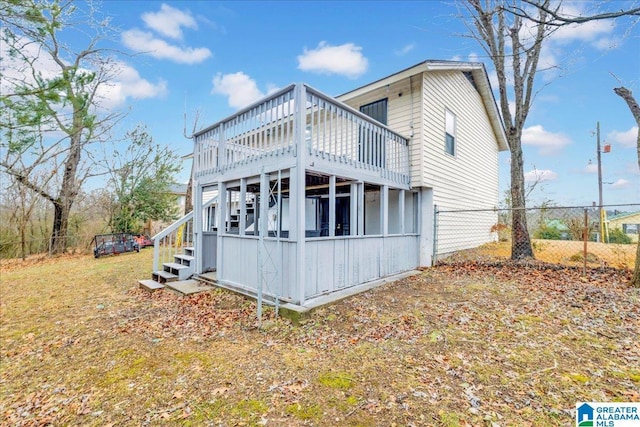 back of property featuring a wooden deck