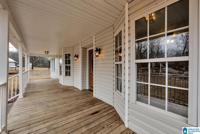 wooden terrace featuring covered porch