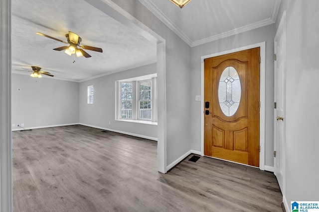 entrance foyer featuring crown molding, ceiling fan, and light hardwood / wood-style flooring