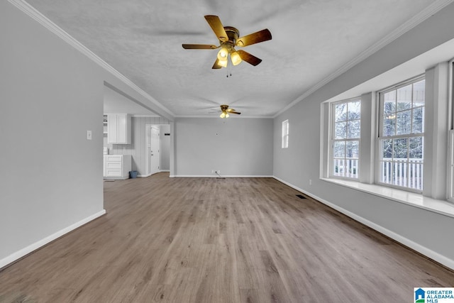 unfurnished living room with a textured ceiling, light hardwood / wood-style flooring, ornamental molding, and ceiling fan