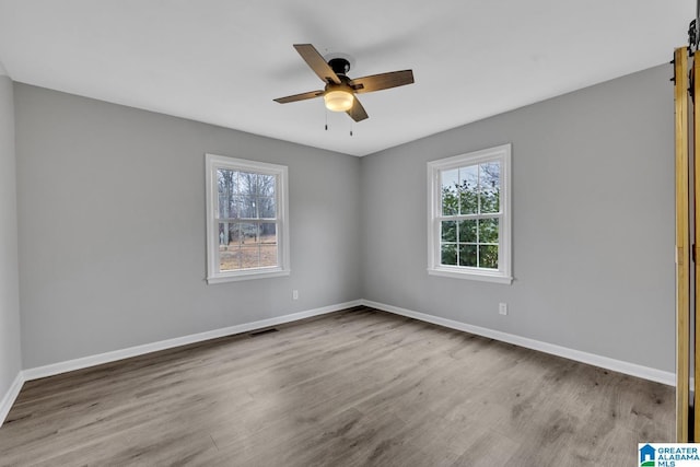 unfurnished room featuring ceiling fan and light wood-type flooring