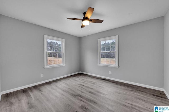 unfurnished room featuring ceiling fan, a healthy amount of sunlight, and light hardwood / wood-style floors