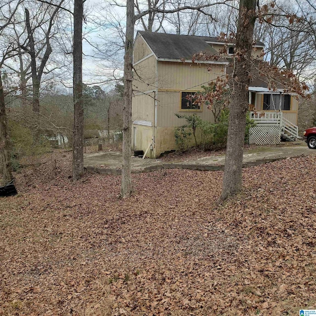 view of side of property featuring a wooden deck