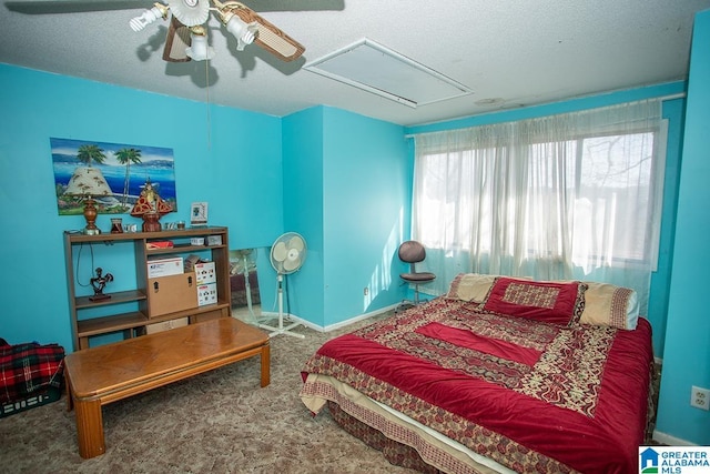 bedroom with ceiling fan, carpet, and a textured ceiling