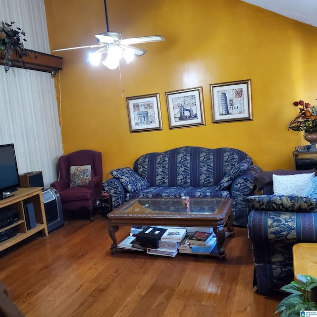 living room featuring hardwood / wood-style flooring, lofted ceiling, and ceiling fan