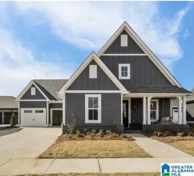 craftsman inspired home with a garage and a porch