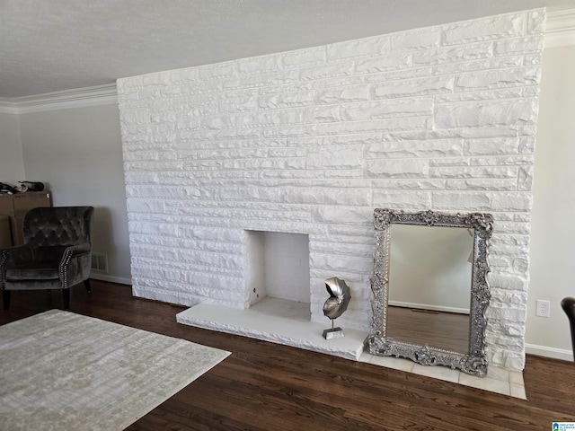 room details featuring hardwood / wood-style flooring, ornamental molding, and a fireplace