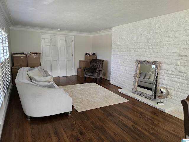 living room featuring ornamental molding, a fireplace, and dark hardwood / wood-style flooring