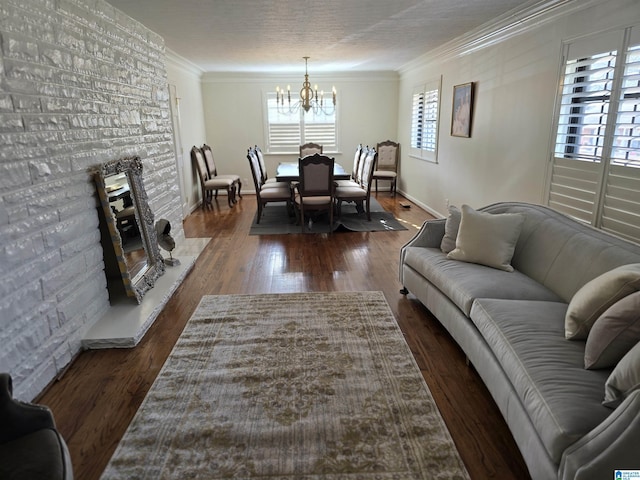 living room featuring ornamental molding, dark hardwood / wood-style floors, and a notable chandelier