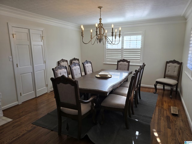 dining area featuring crown molding, dark hardwood / wood-style floors, a textured ceiling, and a chandelier