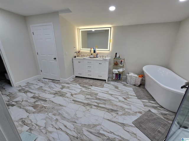 bathroom with vanity and a bath