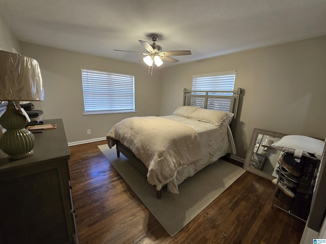 bedroom with dark hardwood / wood-style floors and ceiling fan