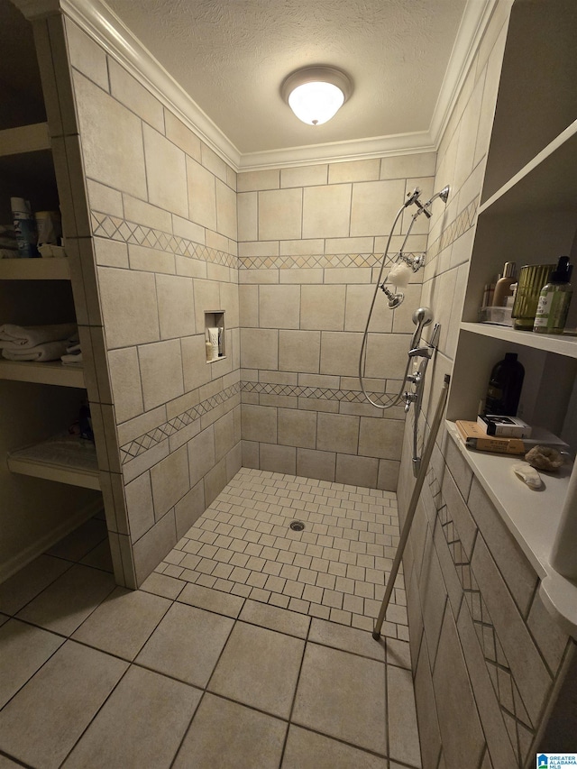 bathroom with crown molding, tiled shower, tile patterned floors, and a textured ceiling