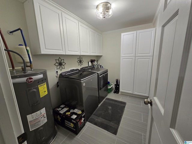 clothes washing area featuring cabinets, crown molding, washer and clothes dryer, and electric water heater