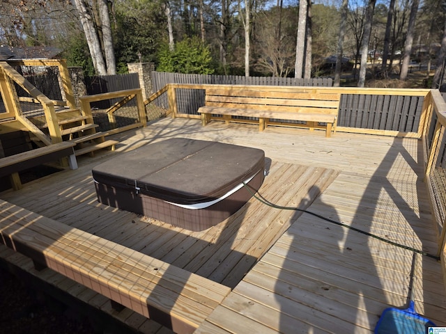 deck featuring a covered hot tub