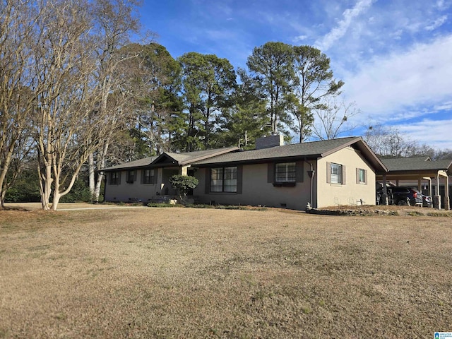 ranch-style house featuring a front yard and a carport