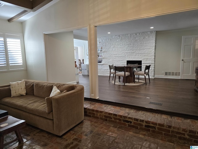 living room featuring vaulted ceiling with beams