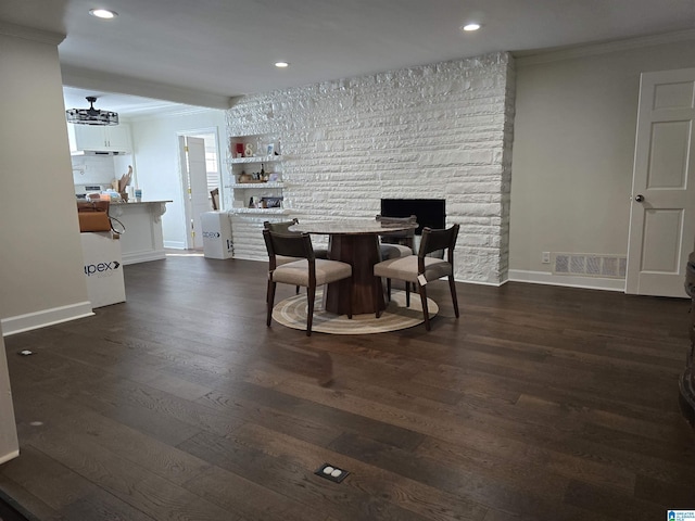 dining space featuring ornamental molding and dark hardwood / wood-style floors