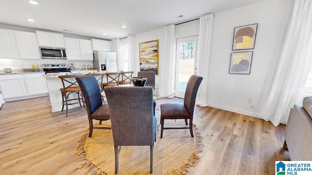 dining space with light hardwood / wood-style flooring