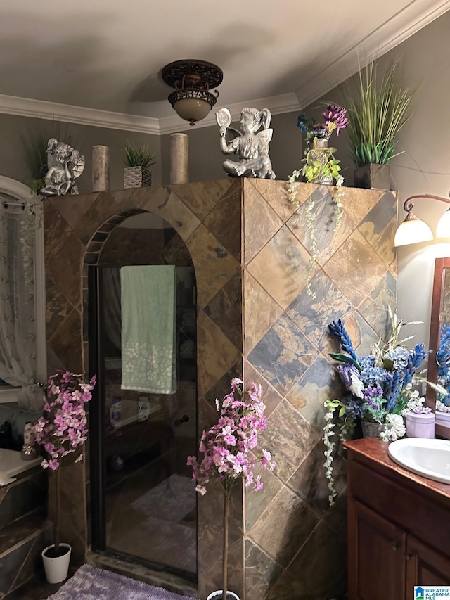 bathroom with crown molding, vanity, and walk in shower