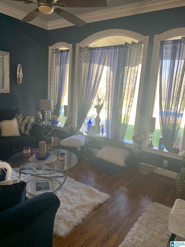 living room with ceiling fan, ornamental molding, and wood-type flooring