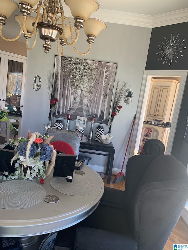 dining room featuring an inviting chandelier, crown molding, and french doors