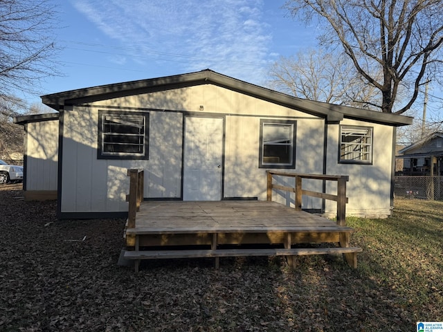 rear view of property featuring a deck