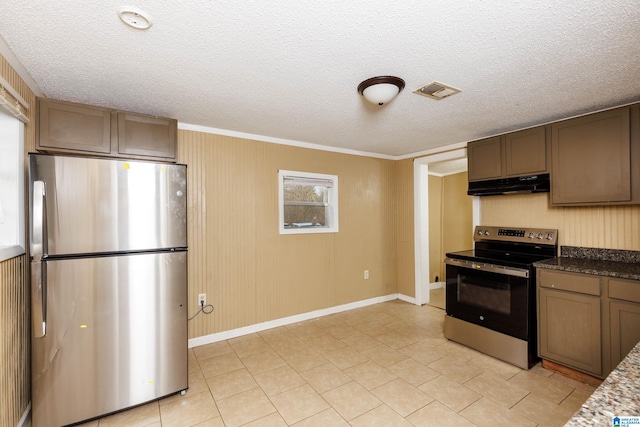 kitchen featuring a textured ceiling, dark stone counters, stainless steel appliances, and light tile patterned floors