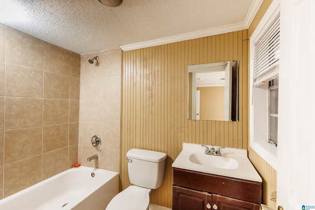 full bathroom with tiled shower / bath, toilet, a textured ceiling, ornamental molding, and vanity