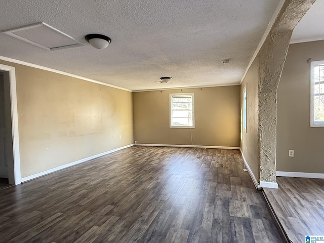 unfurnished room featuring a textured ceiling, ornamental molding, and dark hardwood / wood-style floors