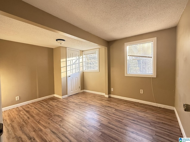 unfurnished bedroom featuring wood-type flooring and a textured ceiling