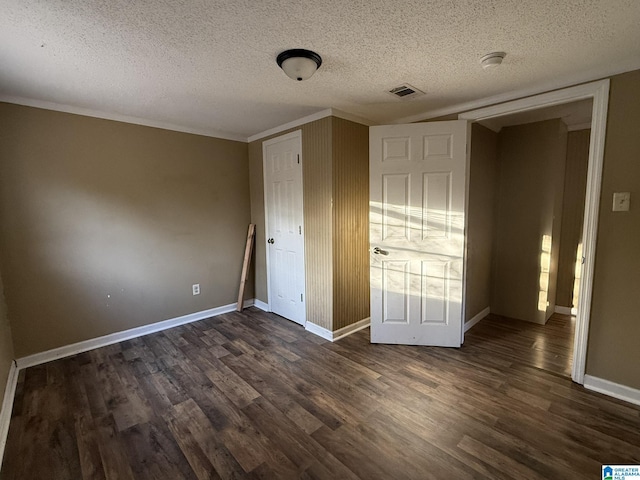 unfurnished bedroom featuring dark hardwood / wood-style flooring and a textured ceiling